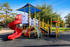 Vibrant playground with colorful slides and climbing structures, perfect for family-friendly communities.
