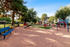 Charming community playground with vibrant slides, benches, and lush greenery, perfect for family enjoyment.
