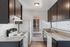 Modern kitchen with sleek dark cabinets, energy-efficient appliances, and ample countertop space, perfect for culinary adventures.