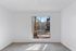 Bright and airy room with large window showcasing a scenic garden view, perfect for relaxation.