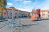 Inviting apartment complex featuring a colorful playground with climbing structures, perfect for family-friendly living.