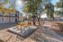 Charming outdoor recreation area with vibrant picnic tables and serene greenery at a welcoming apartment complex under blue skies.