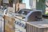 Sleek outdoor BBQ grill station with stainless steel design and modern features, perfect for vibrant gatherings.