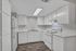 Bright, modern kitchen with sleek white cabinetry, elegant countertops, and stainless steel appliances.