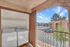 Inviting outdoor laundry area with a washer and dryer, offering convenient home amenities with a balcony view of a vibrant neighborhood.