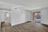 Bright, airy living space with modern wood flooring and large sliding glass doors leading to a sunny balcony.