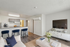 Modern apartment interior featuring an open-concept living area with elegant decor, stylish kitchen bar with seating, and a cozy living room setup.