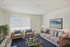 Bright and inviting living room with modern decor, plush seating, and a large window for ample natural light.