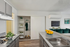 Contemporary kitchen with sleek countertops and vibrant decor, featuring a cozy open-plan living space in modern apartment.