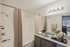 Elegant and modern bathroom with sleek fixtures, a spacious bathtub, and sophisticated vanity, enhanced with virtual staging.