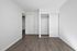 Bright and inviting empty room with sleek hardwood floors and a spacious built-in closet, perfect for customization.