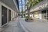 Charming courtyard view of a modern apartment complex with lush greenery and welcoming patios.