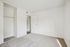 Bright and inviting bedroom featuring fresh carpet flooring, ample closet space, and a minimalist design with abundant natural light.