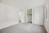 Bright, spacious bedroom with soft carpet flooring, large closet, and ample natural light.