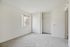 Bright and airy bedroom with plush carpet, large window, and spacious sliding-door closet.