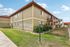 Charming apartment building with a welcoming facade, lush greenery, and pet-friendly amenities, offering relaxed suburban living.