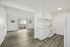 Bright and spacious open-plan living area with modern kitchen, elegant flooring, and large sliding glass doors for natural light.