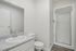 Bright and modern bathroom featuring a sleek granite countertop, sparkling fixtures, and a spacious shower area.