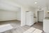 Bright and spacious kitchen with modern flooring, white cabinetry, and open access to living area.