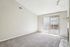 Bright and airy living space with sliding glass doors, offering abundant natural light and seamless outdoor access.