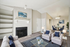 Chic living room with elegant furnishings, a cozy fireplace, open layout leading to a stylish dining area, perfect for modern living.