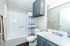 Bright modern bathroom with sleek fixtures, stylish vanity, and colorful shower curtain for a vibrant feel.