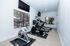 Bright and airy fitness room featuring state-of-the-art exercise equipment with scenic window views, creating a perfect space for invigorating workouts.