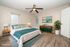 Inviting bedroom with modern decor, featuring a cozy queen-sized bed, sleek furniture, and a serene atmosphere complemented by natural light and stylish flooring.