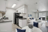 Modern open-concept apartment featuring a sleek black and white kitchen, stylish living room with elegant decor, and soft natural light filtering through large windows.