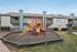 Charming apartment complex with child-friendly playground, vibrant slides, and green surroundings, perfect for family living.