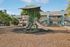 Charming apartment complex with child-friendly playground, vibrant slides, and green surroundings, perfect for family living.