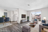Virtually staged living room showcasing modern layout with elegant furnishings, sleek flooring, and abundant natural light from large windows.