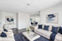 Modern living room with stylish decor, elegant white seating, navy accents, and a cozy dining area, perfect for relaxation and entertainment.