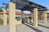 Inviting outdoor BBQ area with pergola, perfect for social gatherings, featuring two grills and a stylish brick design.
