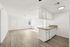 Bright and airy open-plan apartment featuring sleek hardwood floors and a modern kitchen with granite countertops.