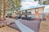 Charming two-story apartment building with modern exterior, featuring private balconies and surrounded by lush trees.