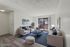Sophisticated living room with plush furniture, modern decor, and a serene balcony view, perfect for relaxation.