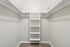 Spacious walk-in closet with elegant shelving and double hanging rods, perfect for organizing your wardrobe.
