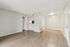 Inviting open-plan living area with elegant wood flooring and modern neutral walls, perfect for a stylish and cozy home.