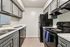 Sleek modern kitchen featuring elegant gray cabinetry, polished granite countertops, and state-of-the-art appliances.