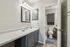 Chic bathroom with a sleek granite countertop, modern fixtures, and elegant lighting, offering a stylish and inviting atmosphere.