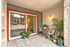 Charming patio with cozy seating, vibrant plants, and a warm ambiance, perfect for relaxation and outdoor enjoyment.