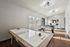 Bright and inviting game room with air hockey and foosball tables, perfect for fun and entertainment.