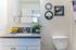 Chic bathroom with sleek vanity, modern fixtures, and stylish decor, perfect for a contemporary living space.