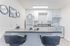 Elegant kitchen with sleek countertops, modern appliances, and stylish bar stools creating a welcoming ambiance.