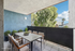 Chic and inviting outdoor balcony with modern seating and lush greenery, offering stunning views and a perfect space for relaxation.