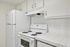 Bright and inviting kitchen featuring modern appliances, sleek cabinetry, and clean tile countertops, perfect for culinary creativity.