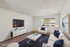 Elegant modern living room with sleek furnishings, stylish decor, and ample natural light.