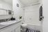 Modern white bathroom featuring sleek fixtures, a stylish vanity, and elegant decor with bright, inviting ambiance.