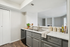 Stylish kitchen with modern gray cabinetry, elegant countertop, and open view to the cozy living area. Perfect for entertaining and culinary creations.